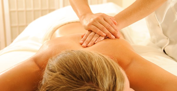 a massage therapist practices what she learned in school upon a client
