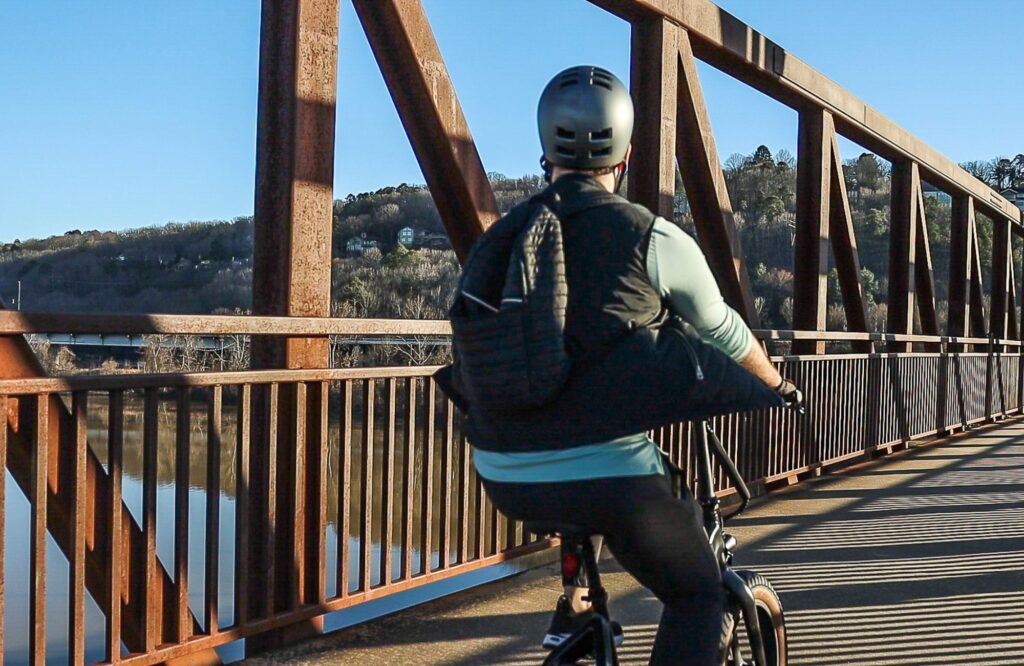 Man commuting across bridge with ebike